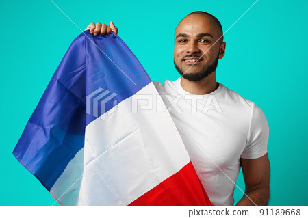 Mixed-race black man holding french flag close up 91189668