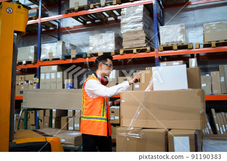 Employee of a logistics warehouse takes an inventory of goods Employee of a logistics warehouse takes an inventory of goods 91190383