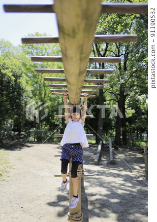 Elementary school girl playing on the escalade (7 years old) 91190532