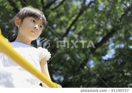 Elementary school girl climbing a jungle gym (7 years old) Elementary school girl climbing a jungle gym (7 years old) 91190557