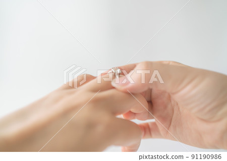 Woman's hand wearing a ring Woman's hand wearing a ring 91190986