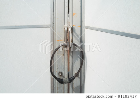 A door with a dial-type wire lock that unlocks with a 4-digit number A door with a dial-type wire lock that unlocks with a 4-digit number 91192417