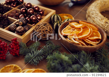 Close-up of Christmas stuff for decorating wreath on wooden table in craft studio, copy space 91194621