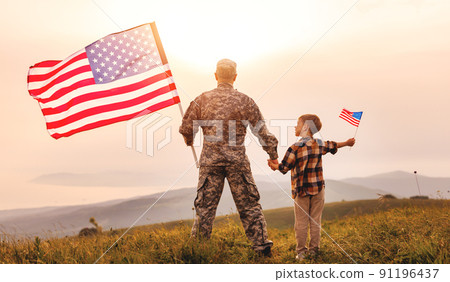 Excited child with american flag holding his father's hand reunited with family Excited child with american flag holding his father's hand reunited with family 91196437