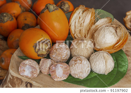 Betel nut or areca nut with betel leaf isolated on wooden background. Betel nut or areca nut with betel leaf isolated on wooden background. 91197902