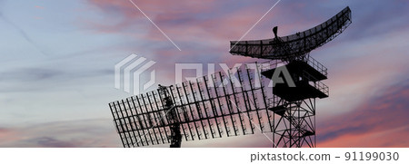 Air defense radars of military mobile anti aircraft systems, modern army industry on the background of the sunset orange sky, Russia 91199030