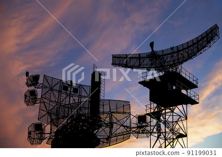 Air defense radars of military mobile anti aircraft systems, modern army industry on the background of the sunset orange sky, Russia 91199031
