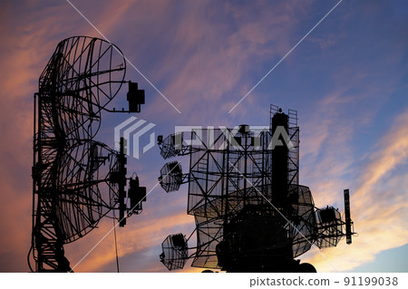 Air defense radars of military mobile anti aircraft systems, modern army industry on the background of the sunset orange sky, Russia 91199038