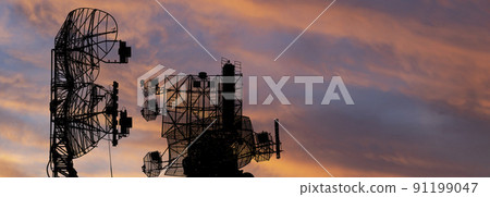 Air defense radars of military mobile anti aircraft systems, modern army industry on the background of the sunset orange sky, Russia 91199047