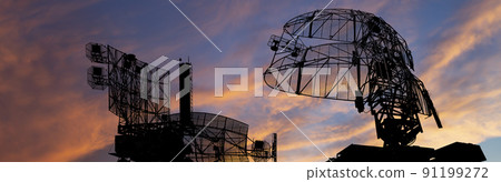 Air defense radars of military mobile anti aircraft systems, modern army industry on the background of the sunset orange sky, Russia 91199272