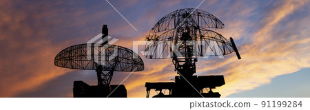 Air defense radars of military mobile anti aircraft systems, modern army industry on the background of the sunset orange sky, Russia Air defense radars of military mobile anti aircraft systems, modern army industry on the background of the sunset orange sky, Russia 91199284