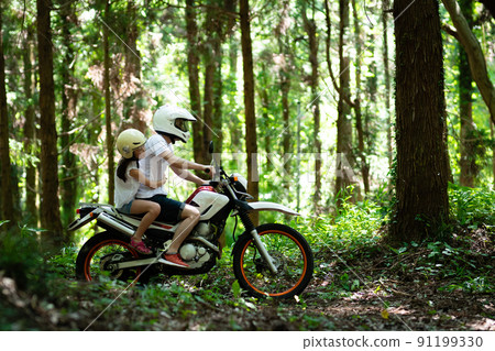 Parents and children running on mountain roads on off-road bikes Parents and children running on mountain roads on off-road bikes 91199330