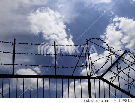 Contour of barbed wire on background beautiful clouds and sky Contour of barbed wire on background beautiful clouds and sky 91199816