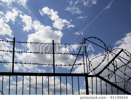 Contour of barbed wire on background beautiful clouds and sky Contour of barbed wire on background beautiful clouds and sky 91199840