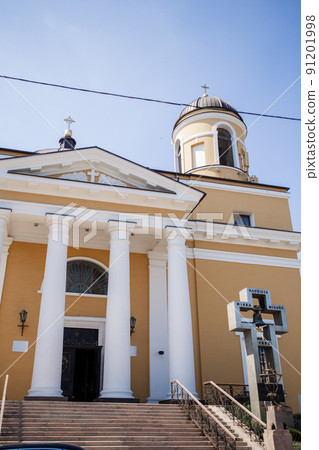 entrance to a large catholic church with white columns 91201998