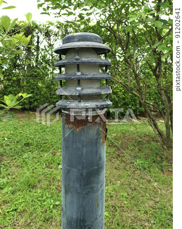 Old lighting pole in garden Old lighting pole in garden 91202641
