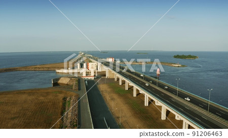 Aerial low altitude shot of a modern highway across the sea. Saint Petersburg, Russia Aerial low altitude shot of a modern highway across the sea. Saint Petersburg, Russia 91206463
