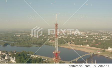 Aerial shot of a mobile telecom tower emitting visualized digital signals, technology related conceptual shot Aerial shot of a mobile telecom tower emitting visualized digital signals, technology related conceptual shot 91206464