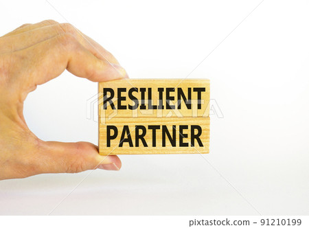 Resilient partner symbol. Concept words Resilient partner on wooden blocks on a beautiful white table white background. Businessman hand. Business resilience resilient partner concept, copy space. Resilient partner symbol. Concept words Resilient partner on wooden blocks on a beautiful white table white background. Businessman hand. Business resilience resilient partner concept, copy space. 91210199