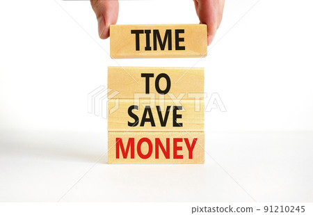 Time to save money symbol. Concept words Time to save money on wooden blocks on a beautiful white table white background. Businessman hand. Business, finacial and time to save money concept. Time to save money symbol. Concept words Time to save money on wooden blocks on a beautiful white table white background. Businessman hand. Business, finacial and time to save money concept. 91210245