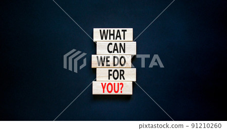 Support symbol. Concept words What can we do for you on wooden blocks on a beautiful black table black background. Copy space. Business motivational and support concept. 91210260