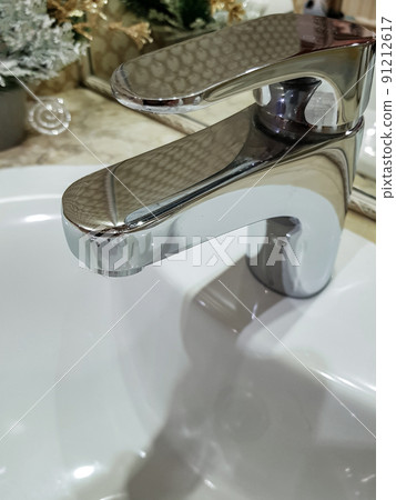 Bathroom interior with luxury chrome sink faucet. Modern design 91212617