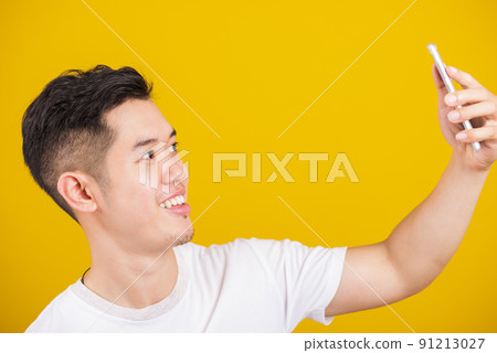 happy male taking selfie on smartphone happy male taking selfie on smartphone 91213027