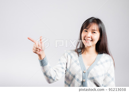 Smiling happy woman pointing finger out space 91213038