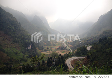 Winding mountain road among the karst mountains in Dong Van Karst Plateau Geopark in North Vietnam 91222864