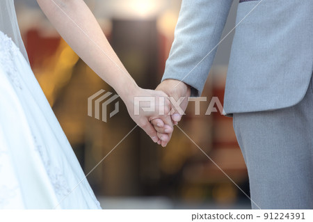 Bride and bridegroom married hands when sun is falling. background. 91224391