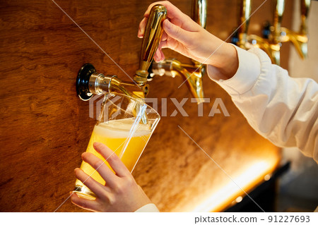 Craft beer poured from the server 91227693
