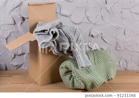 wool sweaters packed in a cardboard box to be sent to the customer, the concept wool sweaters packed in a cardboard box to be sent to the customer, the concept 91231168