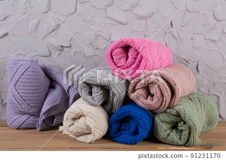 assortment of colored knitted sweaters, folded in rolls, prepared for shipment to customers assortment of colored knitted sweaters, folded in rolls, prepared for shipment to customers 91231170