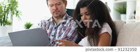 Middle aged man and latino american woman choosing something online 91232350