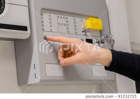 Close-up of electrician Checking Fire Alarm Panel In Datacenter Close-up of electrician Checking Fire Alarm Panel In Datacenter 91232725