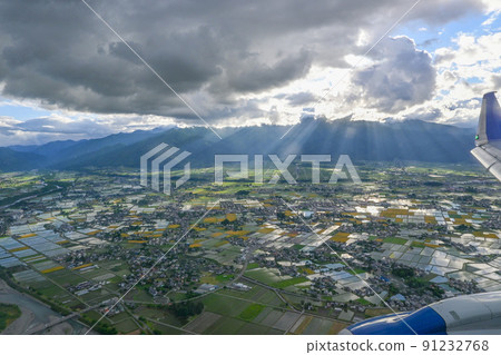 Looking at Matsumoto city from an airplane under cloudy weather Matsumoto city, Nagano prefecture, where light shines through the clouds Looking at Matsumoto city from an airplane under cloudy weather Matsumoto city, Nagano prefecture, where light shines through the clouds 91232768