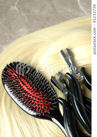 Composition with hair extension accessories on gray textured background 91233739