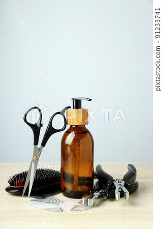 Composition with hair extension accessories on wooden table 91233741