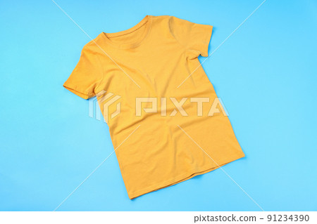 Blank yellow t-shirt with space for print on blue background Blank yellow t-shirt with space for print on blue background 91234390