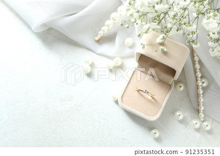Concept of wedding accessories with wedding ring, close up Concept of wedding accessories with wedding ring, close up 91235351