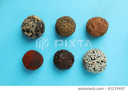 Flat lay composition with truffles on blue background 91235497
