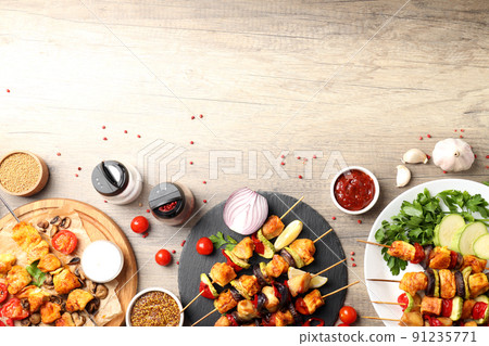 Concept of tasty food with chicken shashlik on light wooden background Concept of tasty food with chicken shashlik on light wooden background 91235771