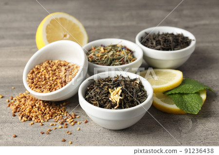 Concept of cooking tea with different types of tea on gray wooden background 91236438