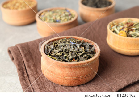 Concept of cooking tea with different types of tea on light textured background Concept of cooking tea with different types of tea on light textured background 91236462