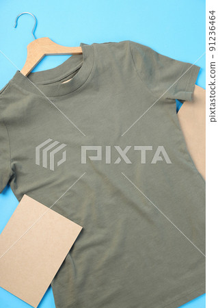 Blank t-shirt, bag and carton sheet on blue background Blank t-shirt, bag and carton sheet on blue background 91236464