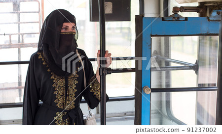 Muslim woman in public transport going to work Muslim woman in public transport going to work 91237002