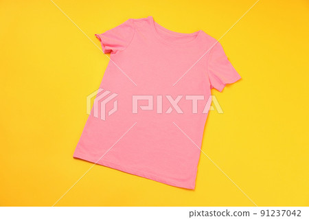 Blank pink t-shirt with space for print on yellow background Blank pink t-shirt with space for print on yellow background 91237042
