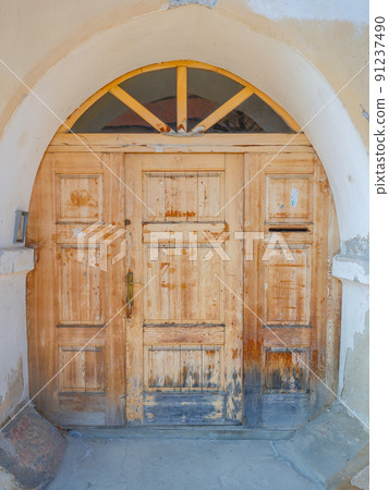 Detailed view of a richly shaped wooden door. 91237490
