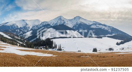 View of the landscape with snowy mountains and ski slopes. 91237505