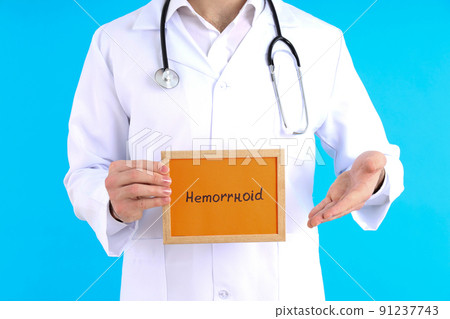 Doctor with text Hemorrhoid on blue background Doctor with text Hemorrhoid on blue background 91237743
